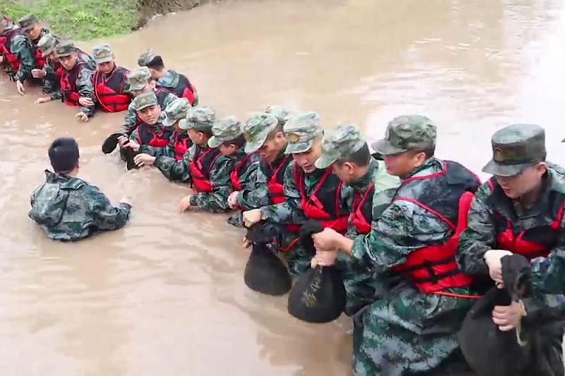 Mission Must Be Reached - The People's Liberation Army and the People's Armed Police Force Strive for Flood Control and Disaster Relief, Putting the People First Military Brigade | Officers and Soldiers | The People's Liberation Army